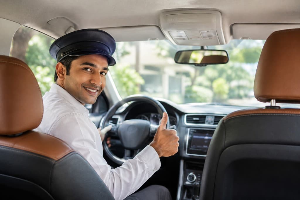 Professional family driver giving a thumbs-up from the car